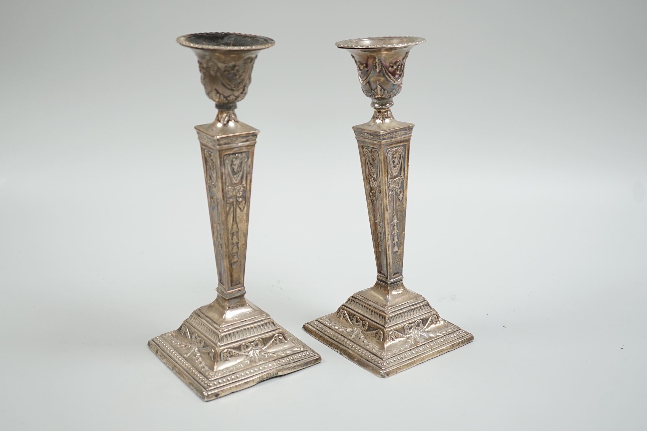 A pair of Edwardian silver mounted Adam's style candlesticks, Richard Richardson, Sheffield, 1905, height 24.8cm, weighted (solder repairs).